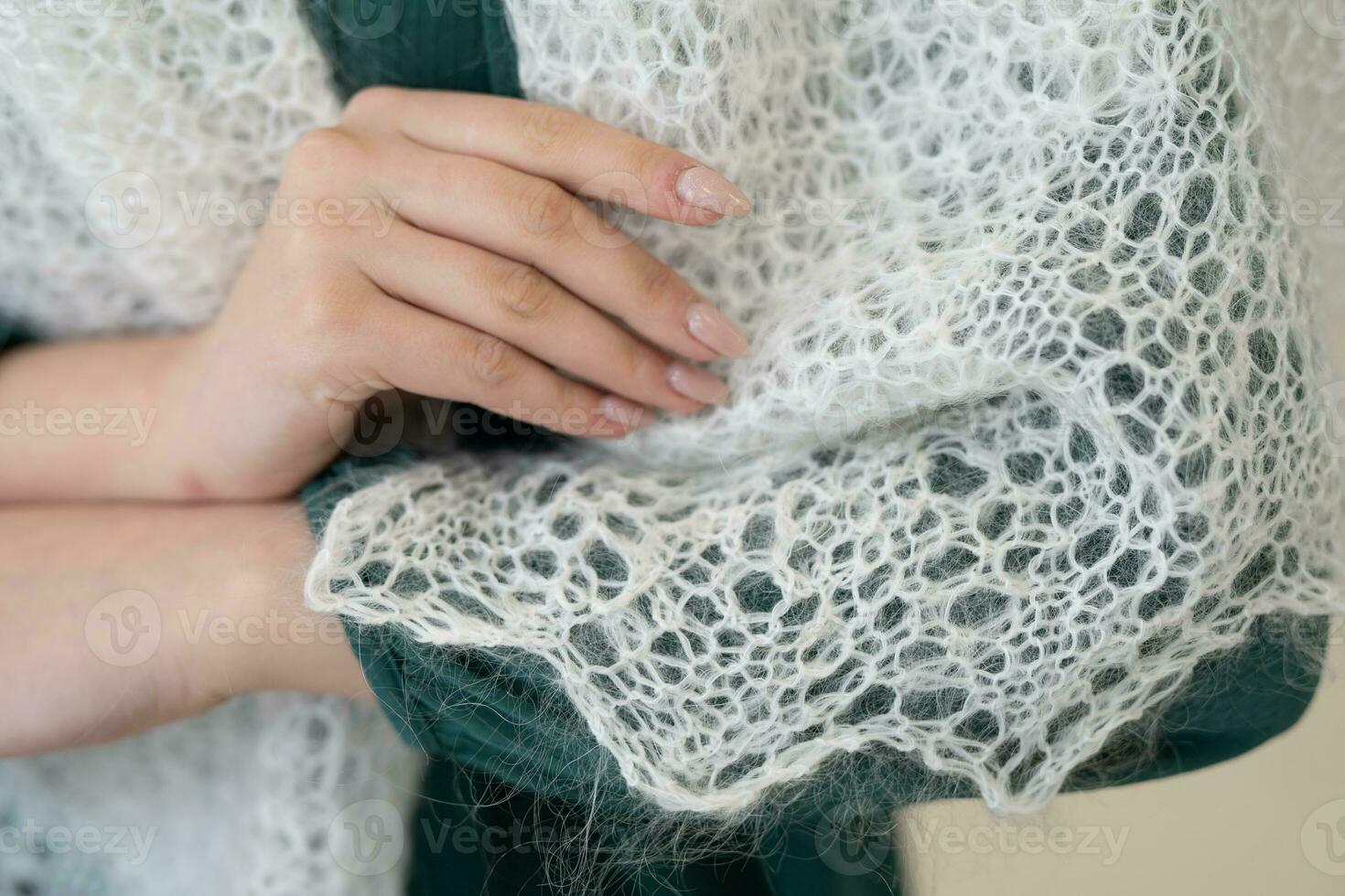 close-up of a warm woolen scarf woman shows on her hand photo