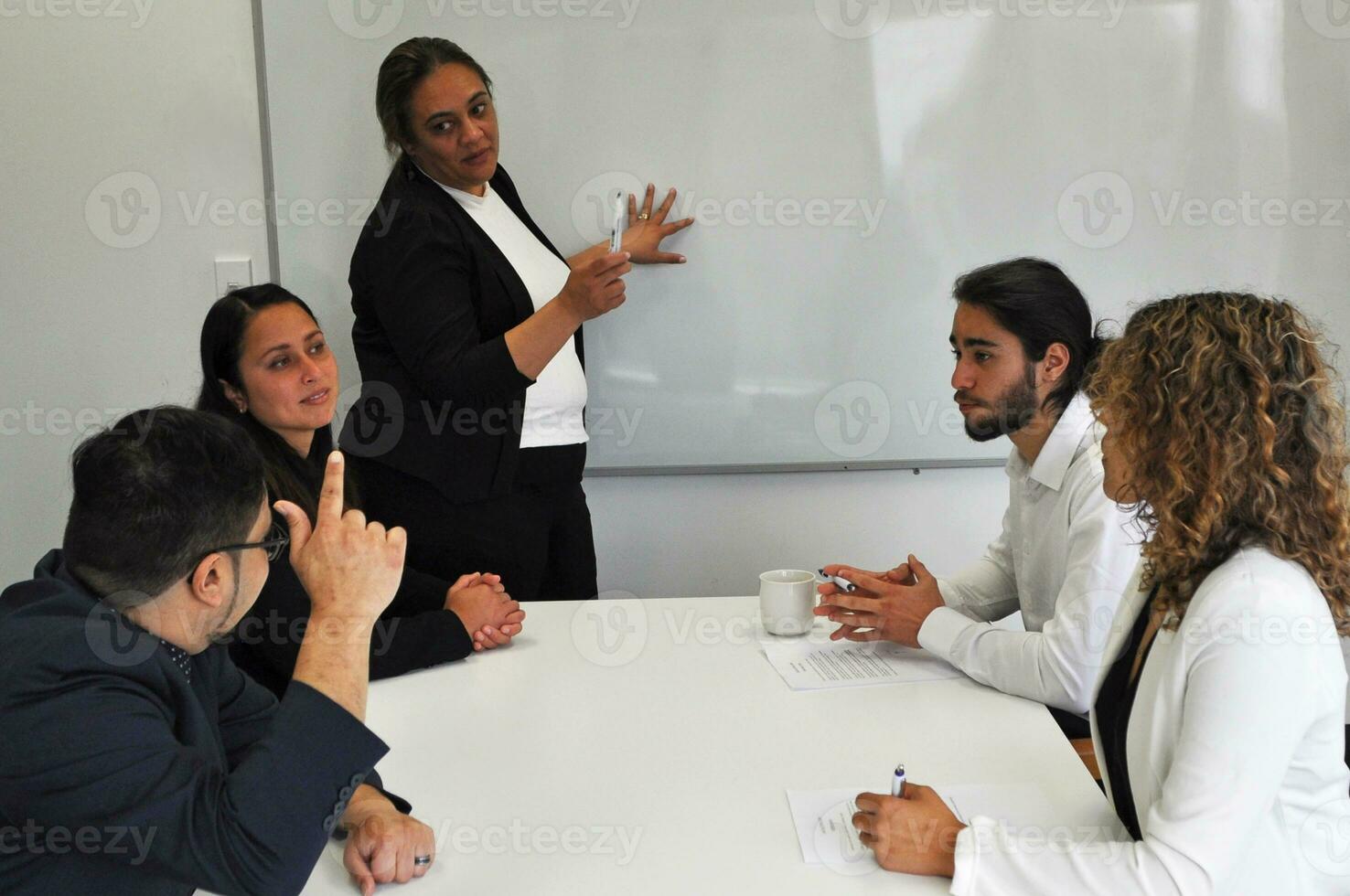 Maori, Pacific Islanders in business setting for meeting and coaching photo