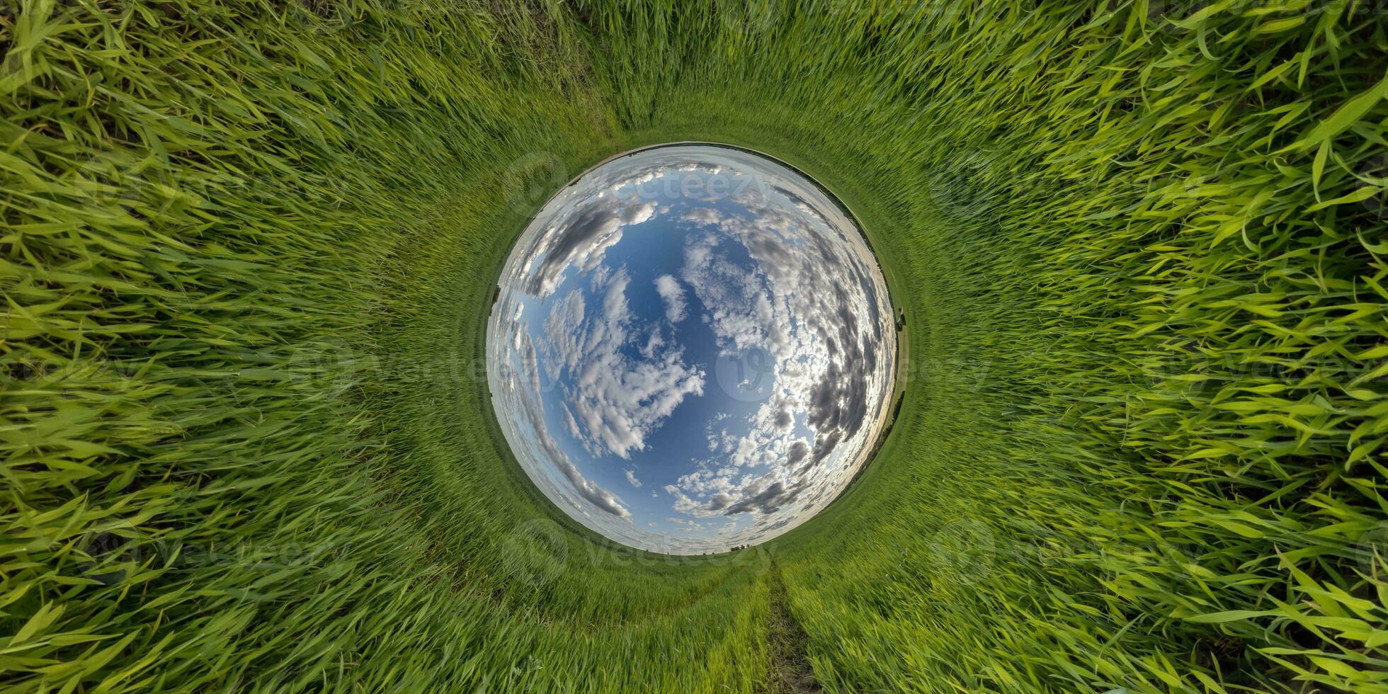 blue hole sphere little planet inside green grass round frame background. photo