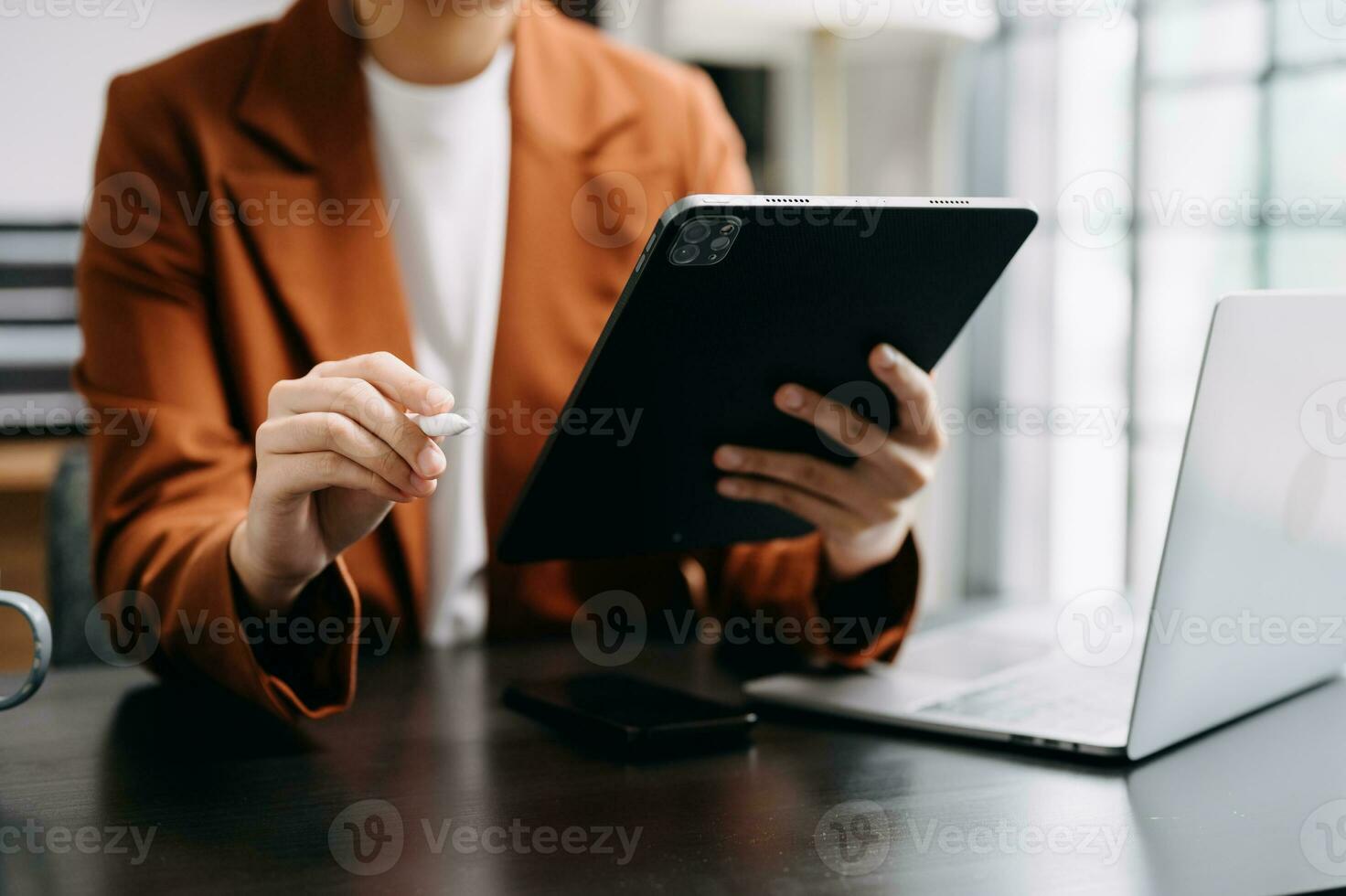 Bussinessman analyzing sales data and economic growth and pointing at business report document with graph chart financial chart marketing, banking and payments at modern office photo