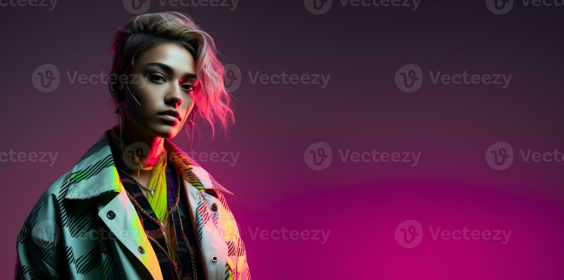 Androgynous model in reflective geometric attire isolated on a neon gradient background photo