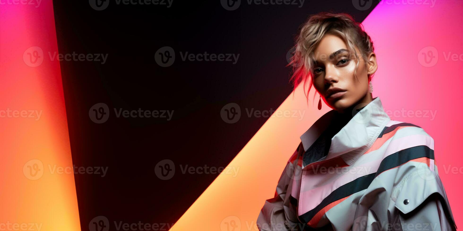 Androgynous model in reflective geometric attire isolated on a neon gradient background photo