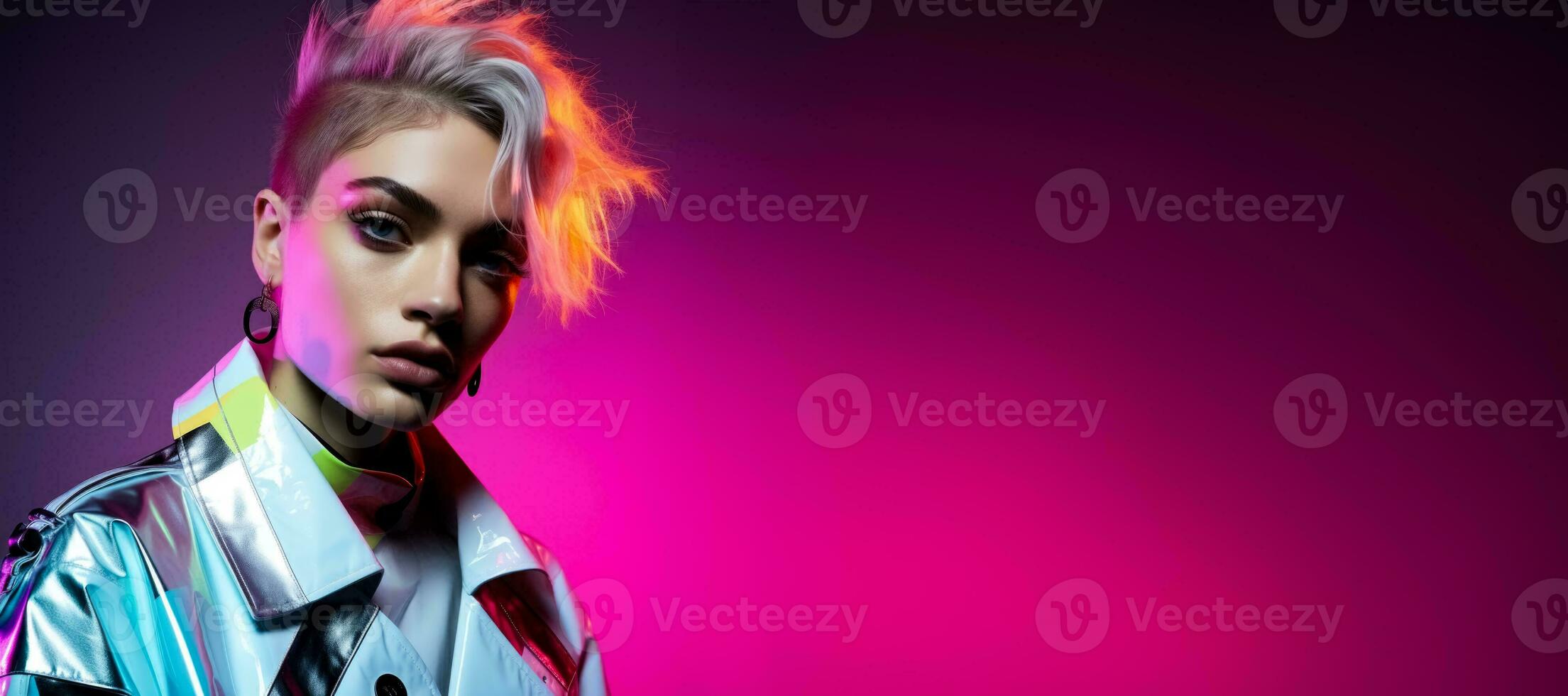 Androgynous model in reflective geometric attire isolated on a neon gradient background photo