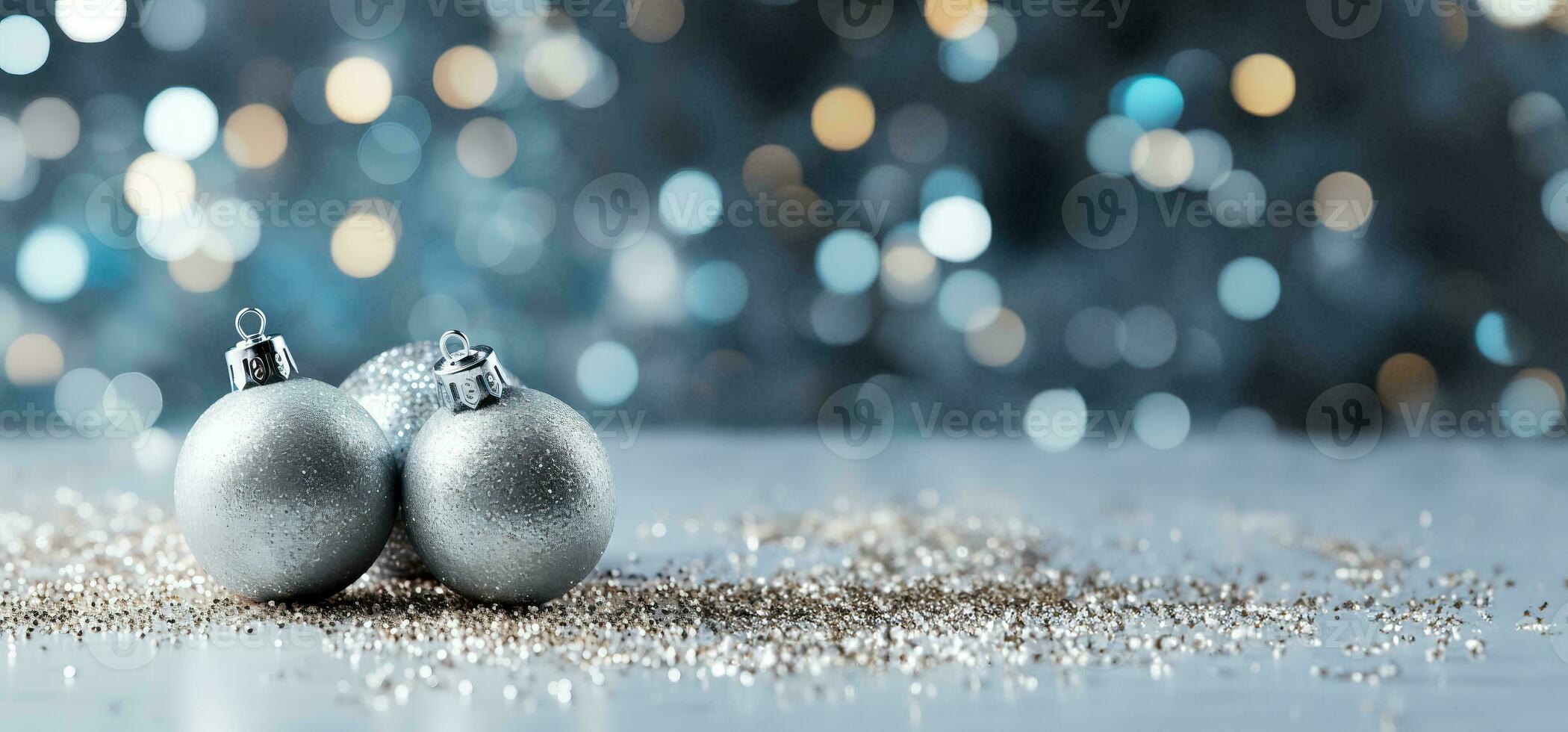 Festive silver Christmas ornaments arranged on sparkly backgrounds providing an elegant background with empty space for text photo