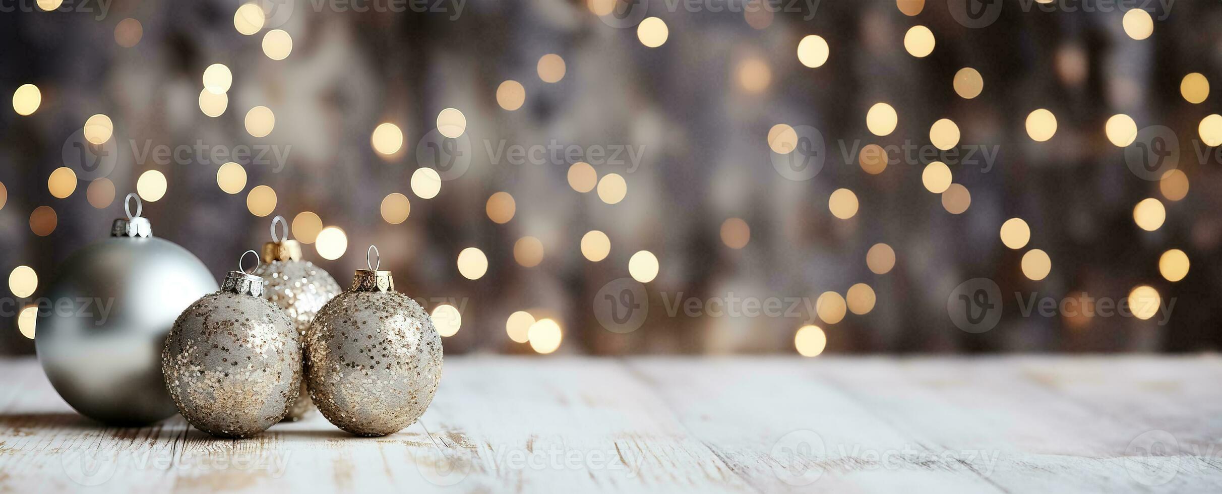 Festive silver Christmas ornaments arranged on sparkly backgrounds providing an elegant background with empty space for text photo