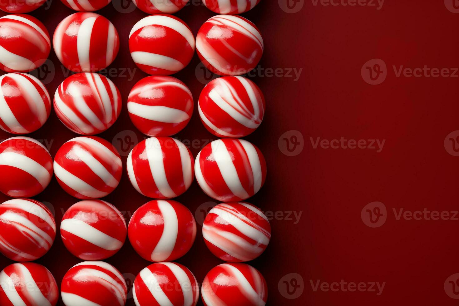 A close-up shot of candy canes arranged on peppermint striped backgrounds with empty space for text photo