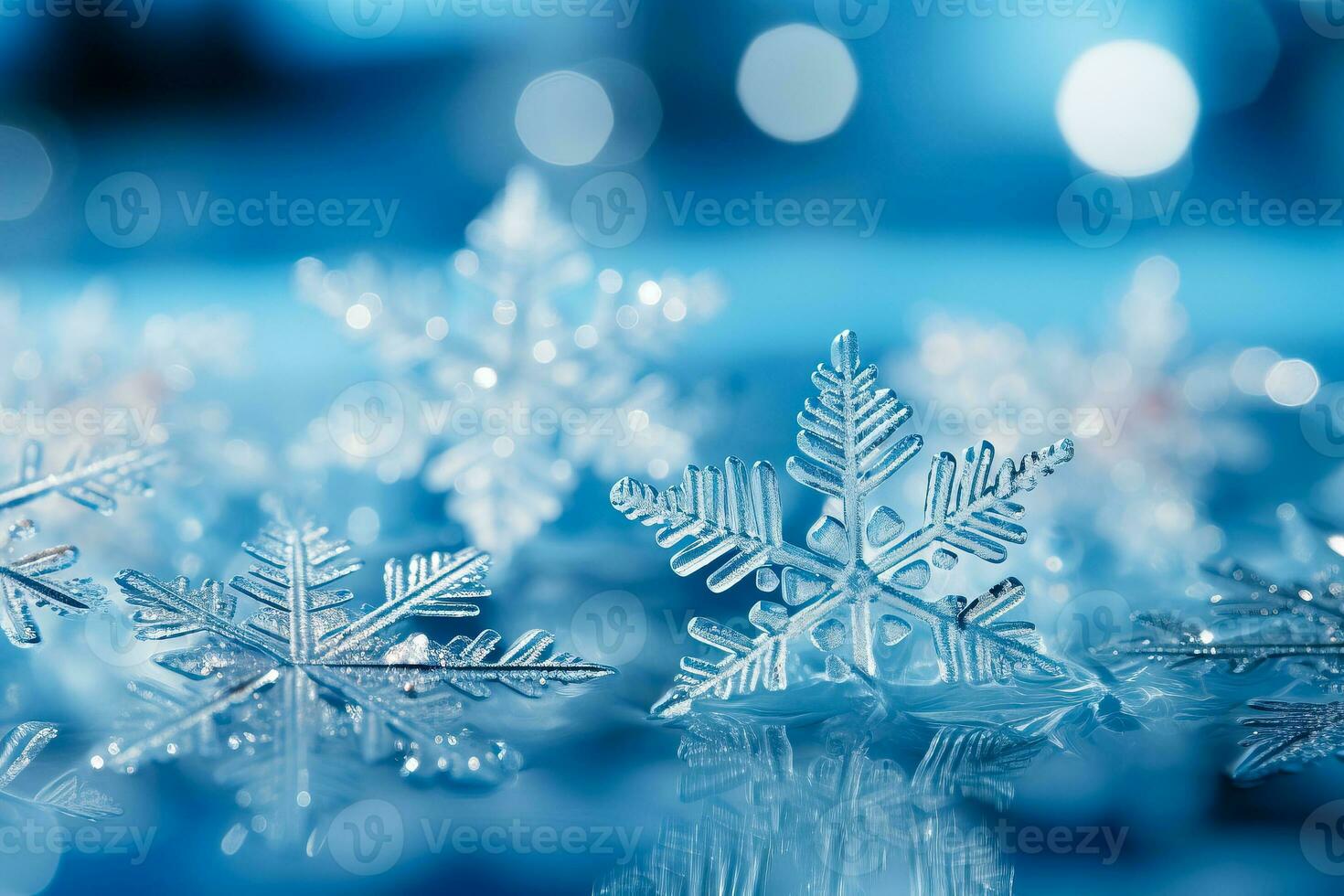 A close-up shot captures intricately detailed snowflakes resting gently on a shimmering icy blue surface photo