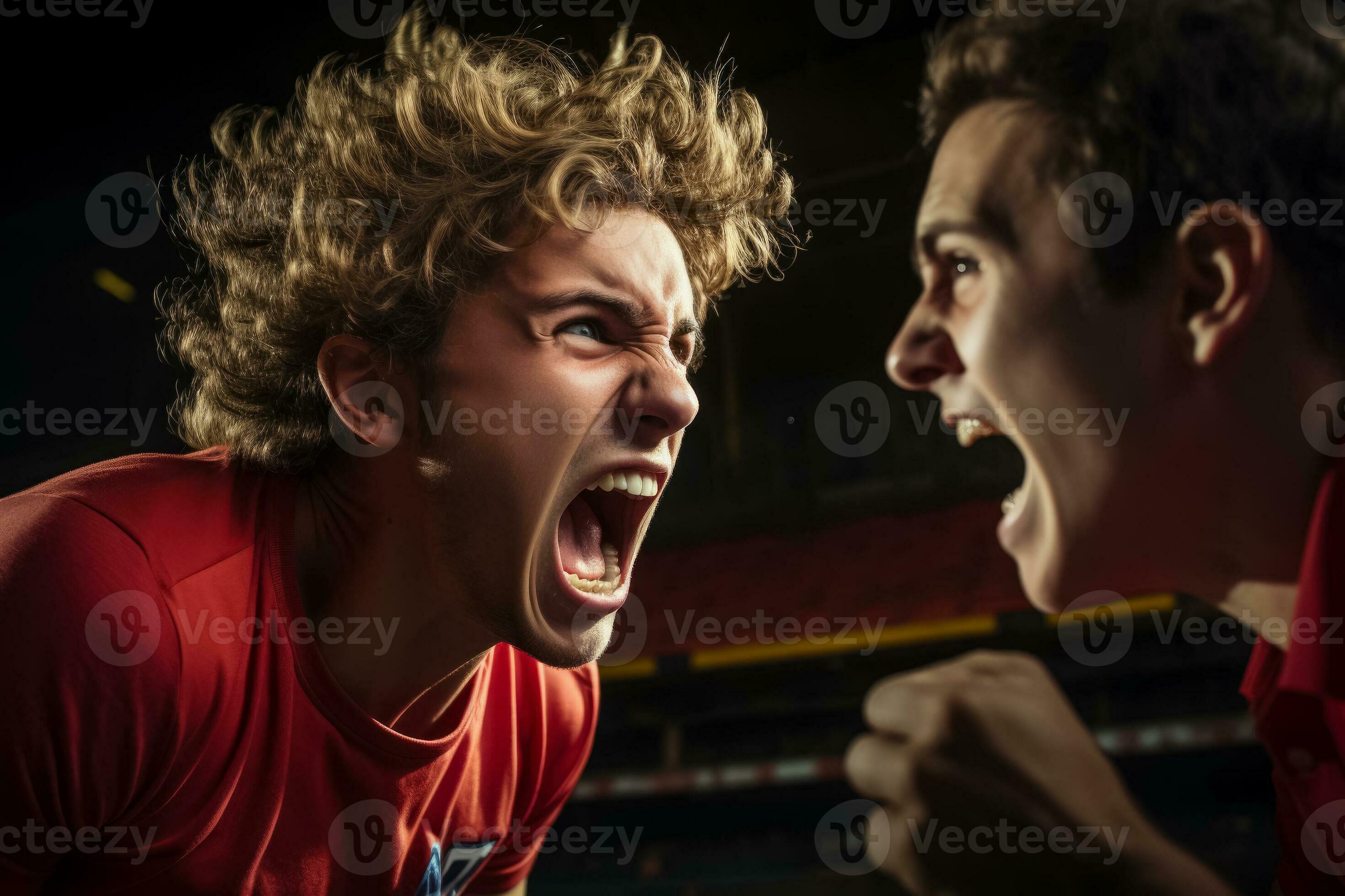 Closeup of a redfaced athlete shouting and pointing aggressively at a