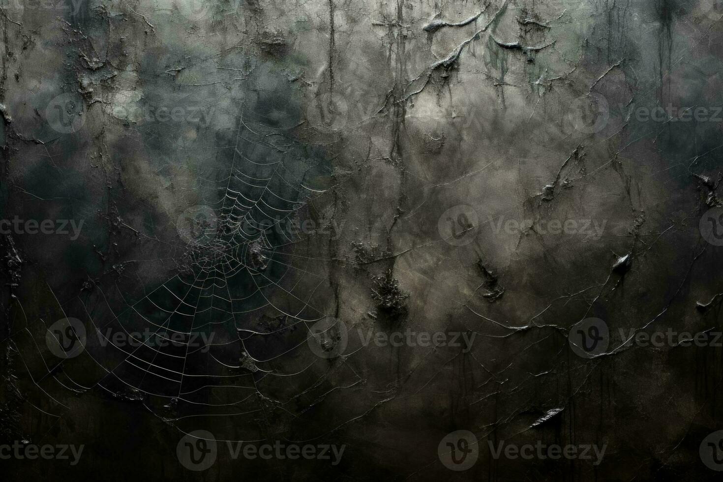 Intricate silver spider webs delicately intertwined casting shadows on a brooding charcoal background photo