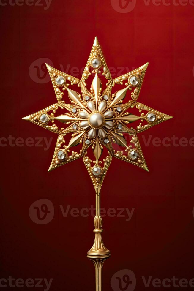Victorian style Christmas tree topper a golden star gleaming with sparkle isolated on a holiday red gradient background photo