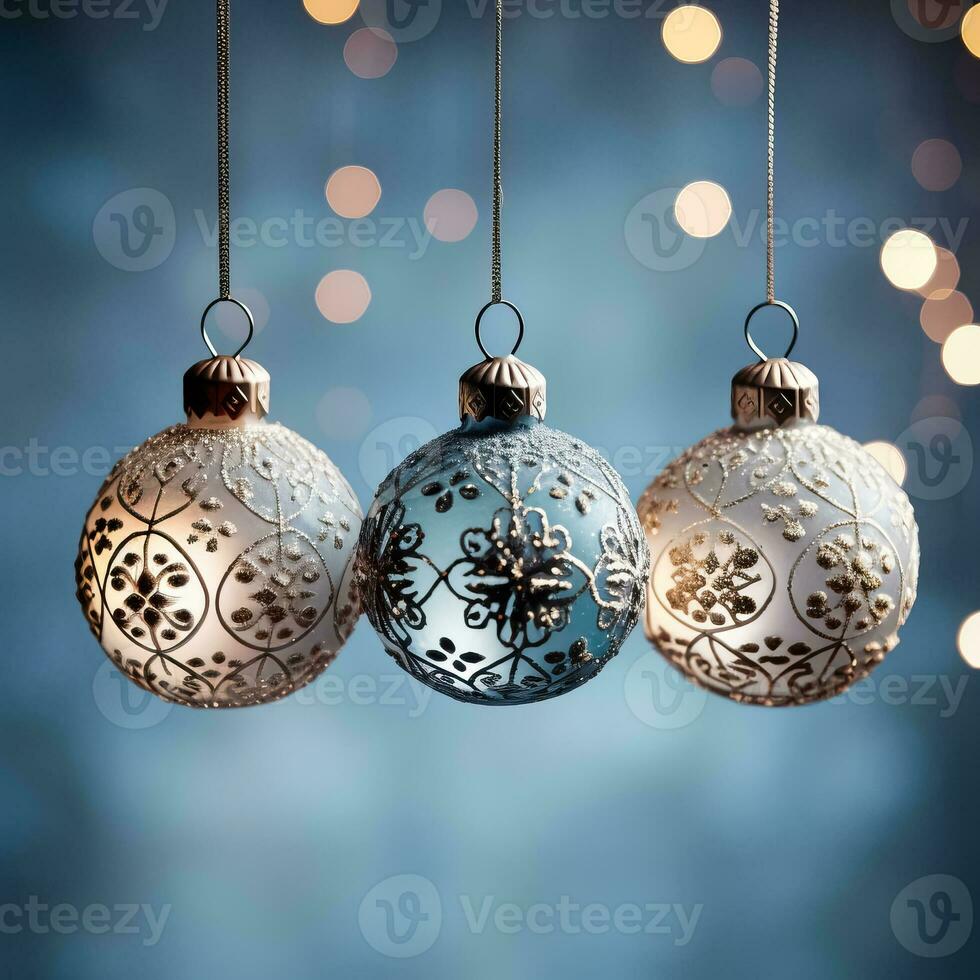 Antique glass ball ornaments kissed with frost hanging isolated on a dusky blue to icy white gradient background photo