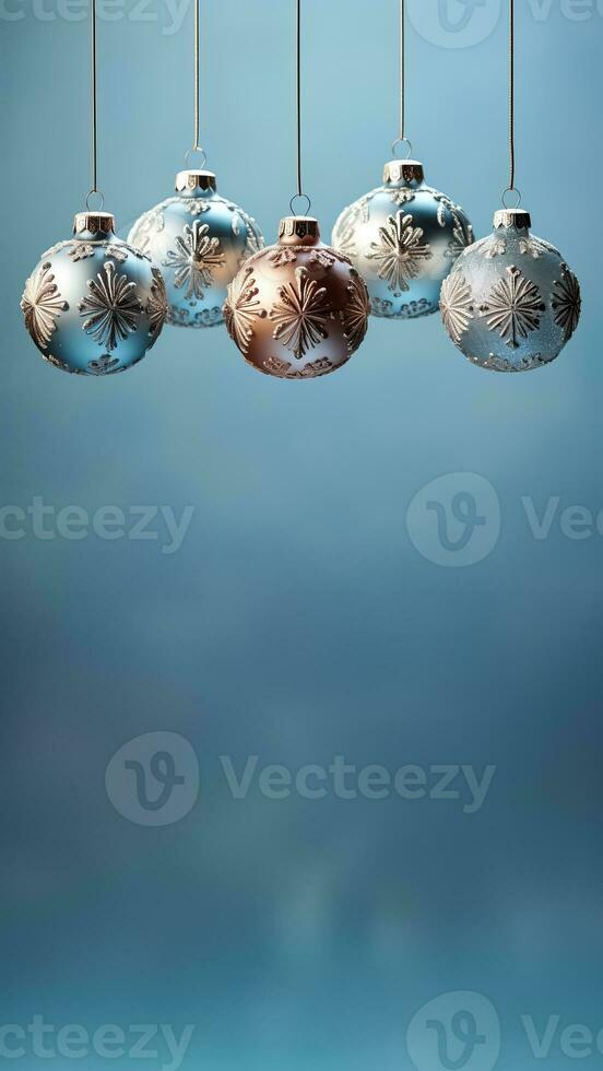 Antique glass ball ornaments kissed with frost hanging isolated on a dusky blue to icy white gradient background photo