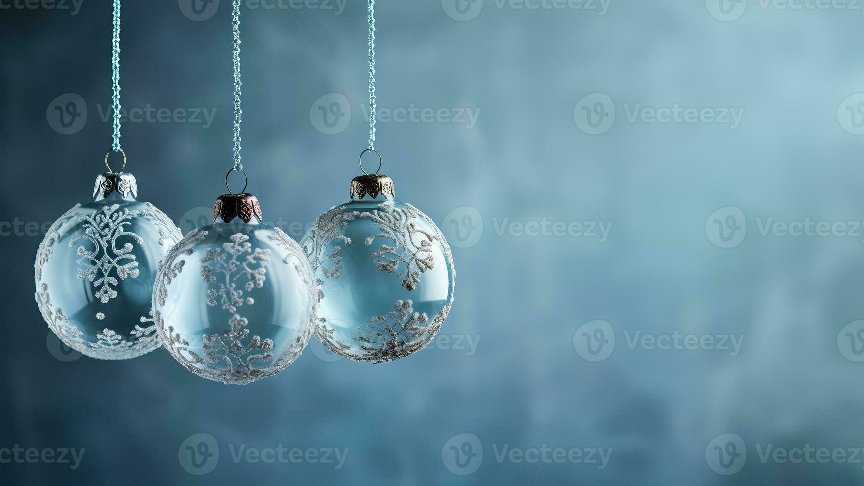 Antique glass ball ornaments kissed with frost hanging isolated on a dusky blue to icy white gradient background photo