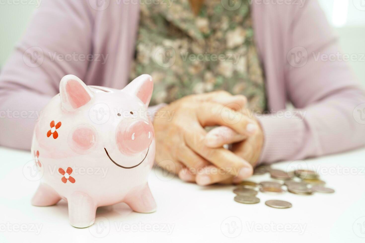 Retired elderly woman counting coins money with piggy bank and worry about monthly expenses and treatment fee payment. photo