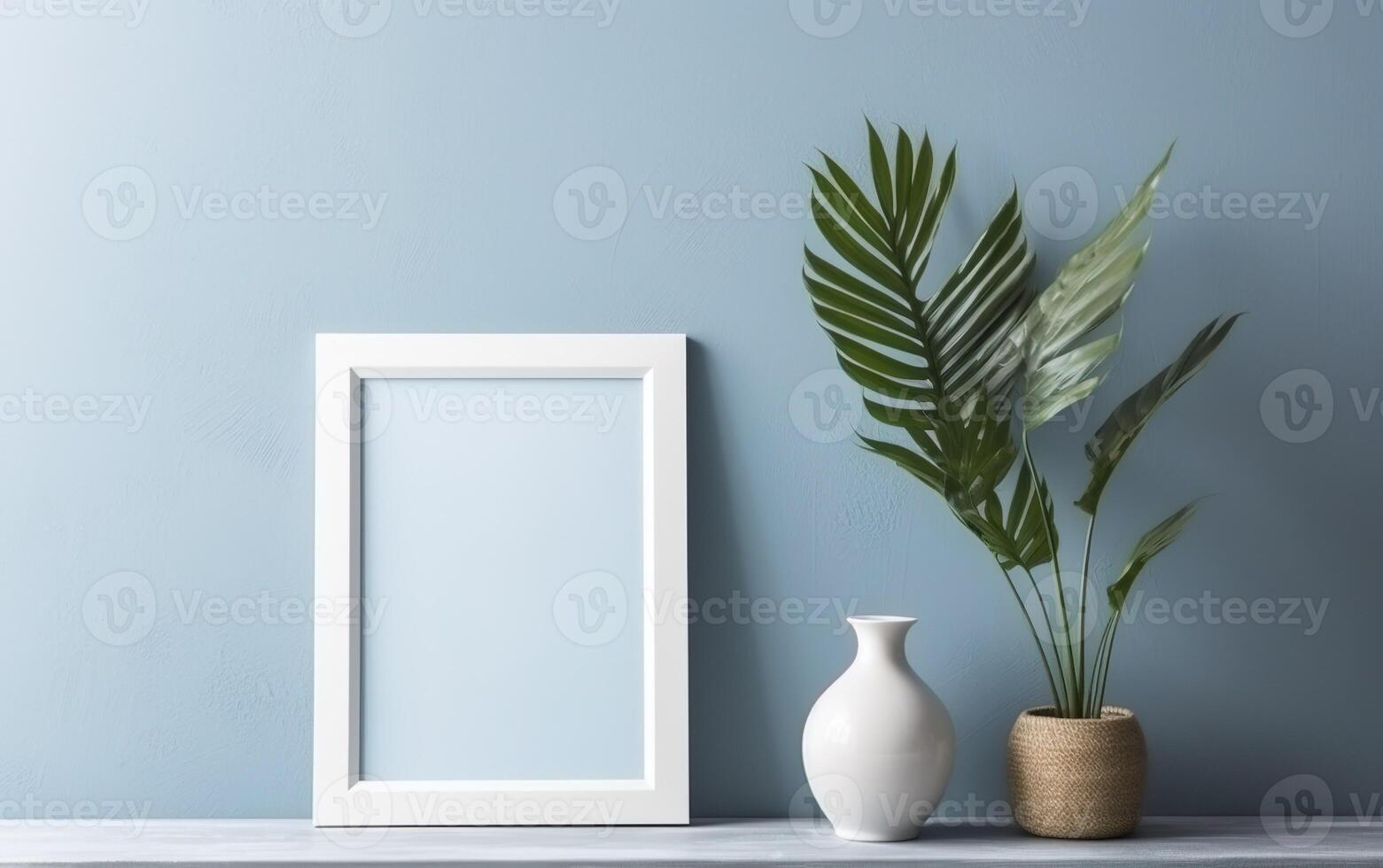 Wooden frame mockup on shelf over blue wall with palm leaves in vase, blank vertical frame with copy space. Contemporary interior mockup. photo