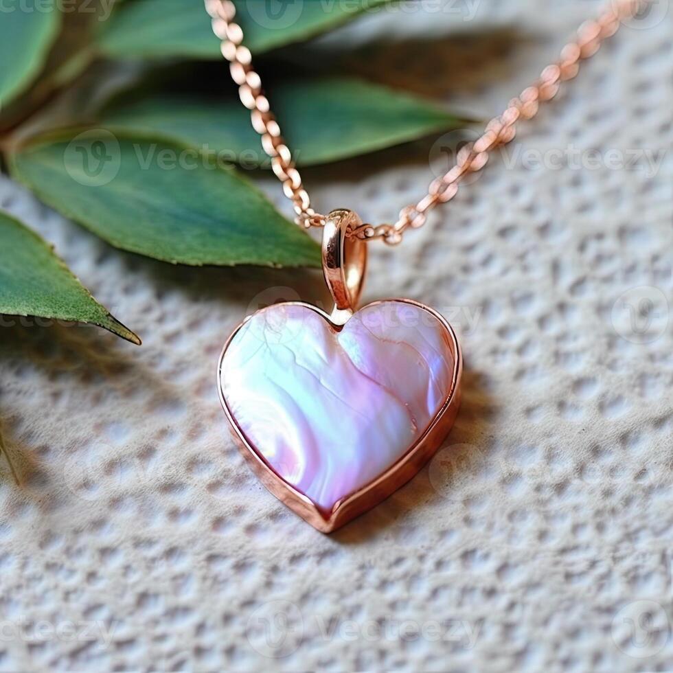 a heart shaped pendant with leaves photo