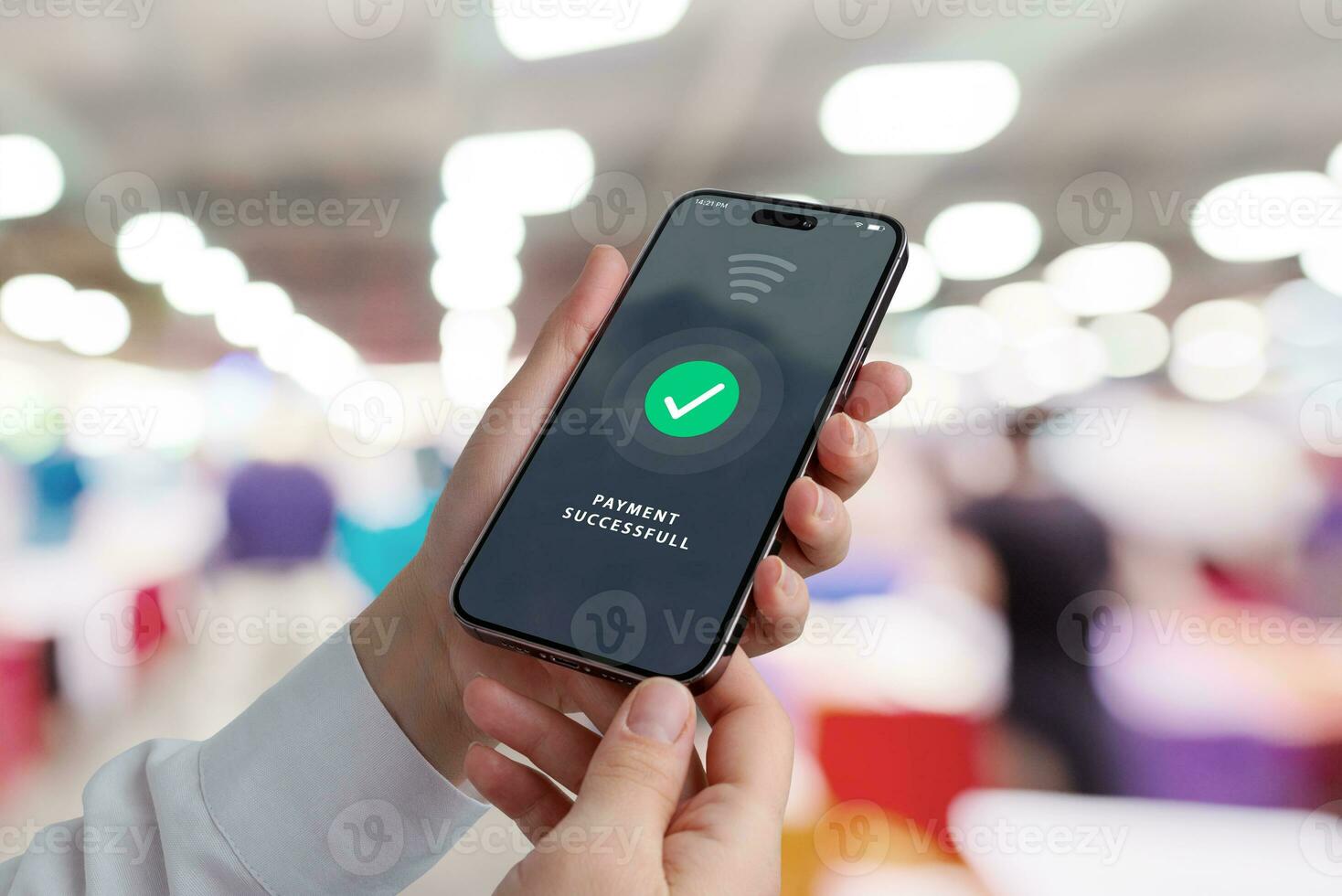 Mobile phone in hands with payment successful notification on display in a shopping store, showcasing modern transactions for a delightful shopping experience photo