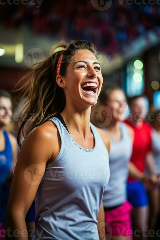 Enthusiastic group performing energetic aerobic exercises in lively fitness club atmosphere photo