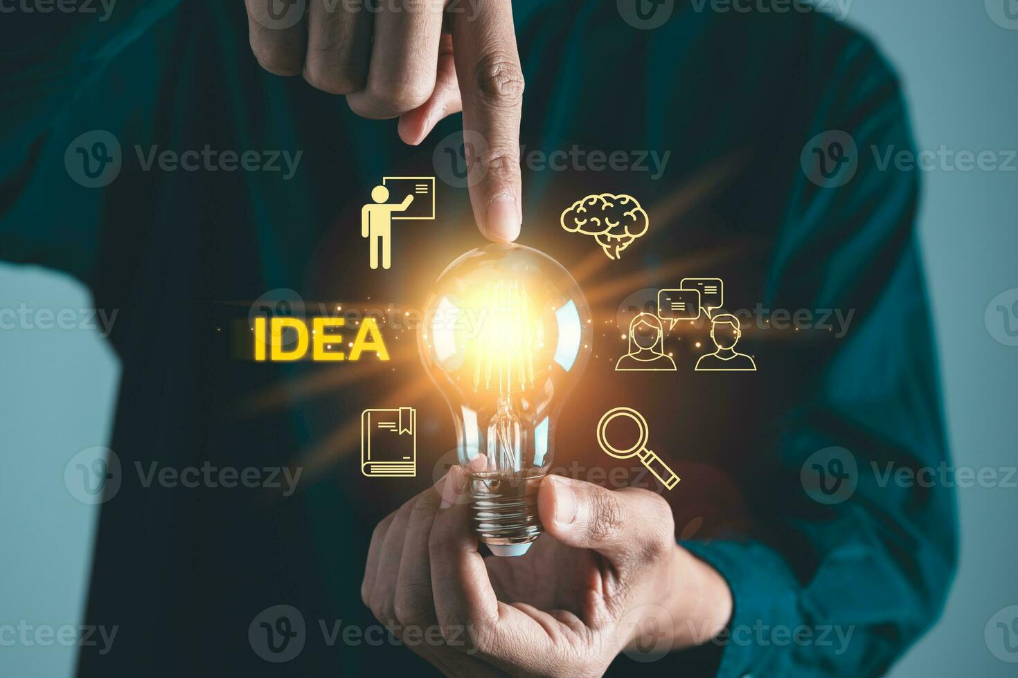Businessman holding light bulb with business idea icons. Teamwork, brainstrom and strategic planning concept photo