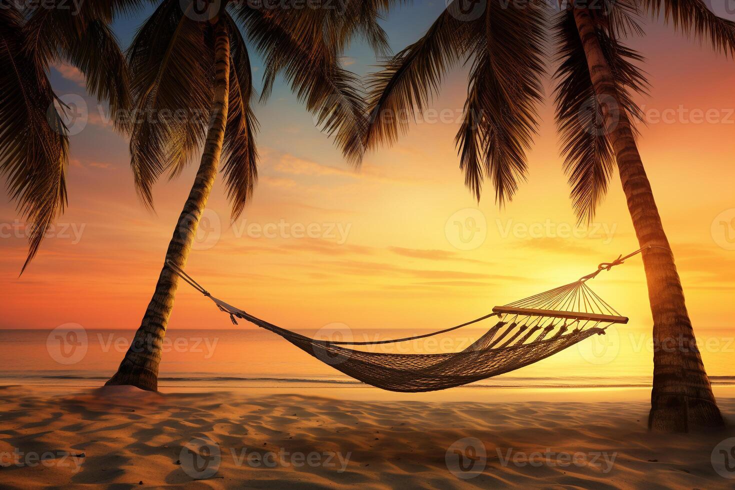 Serene tropical beach scene at sunset with palm trees, a hammock, and soft sand photo