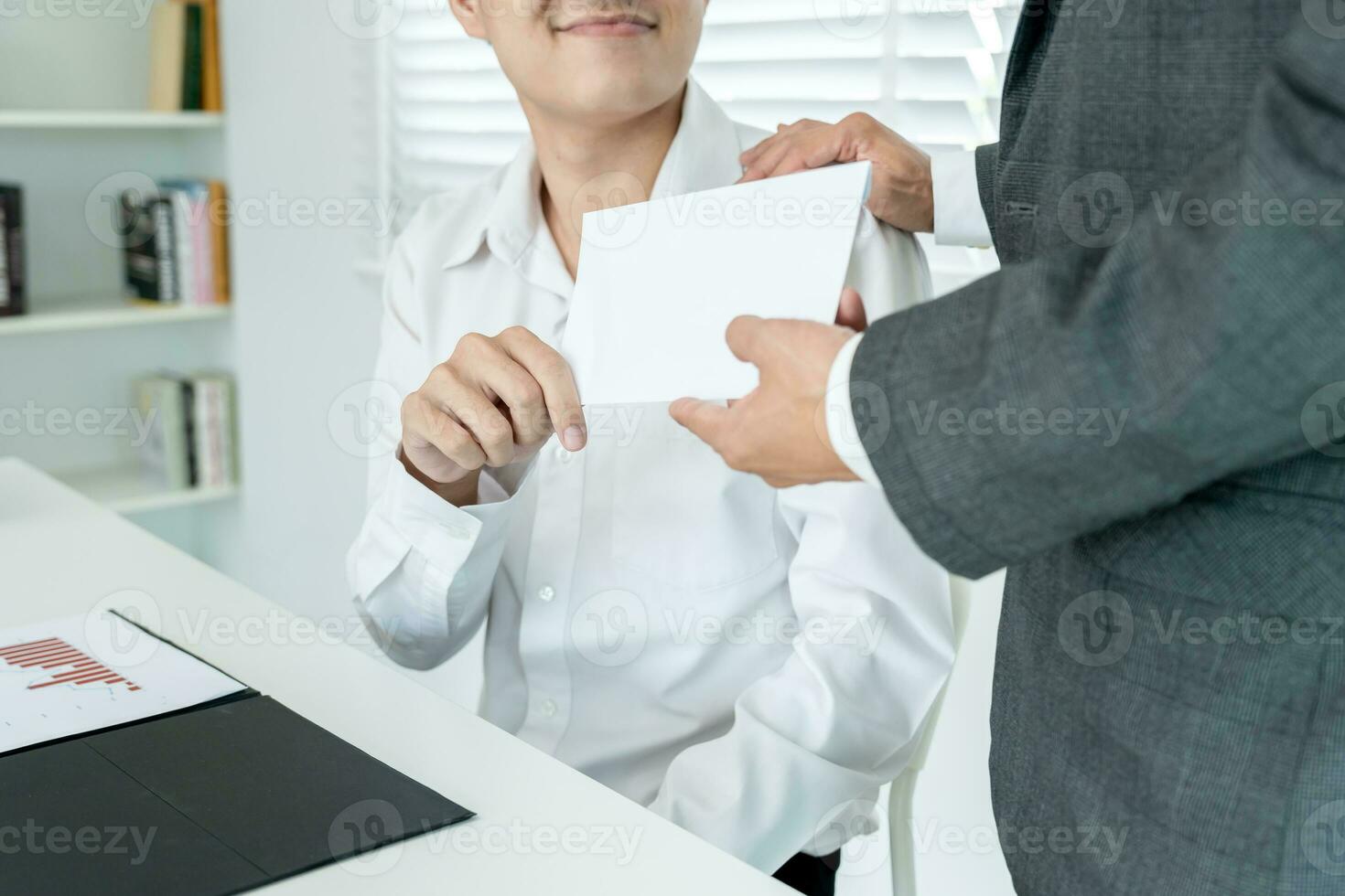 Businessmen receive salary or bonuses from management or Boss. Company give rewards to encourage work. Smiling businessman enjoying a reward at the desk in the offic photo