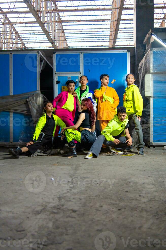 a group of Asian gay men posing around an abandoned building with their friends photo