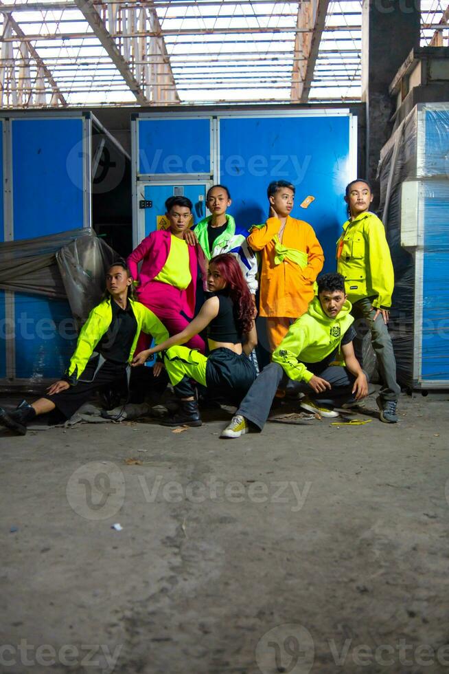 a group of Asian gay men posing around an abandoned building with their friends photo