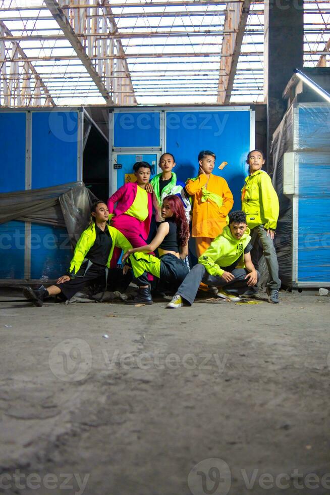 a group of Asian gay men posing around an abandoned building with their friends photo