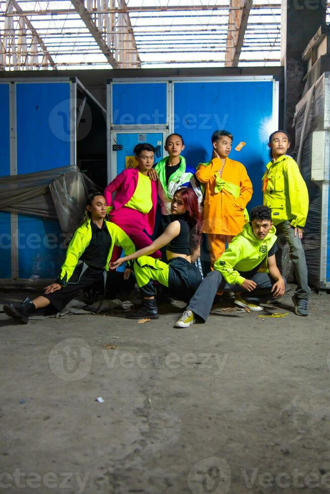 a group of Asian gay men posing around an abandoned building with their friends photo