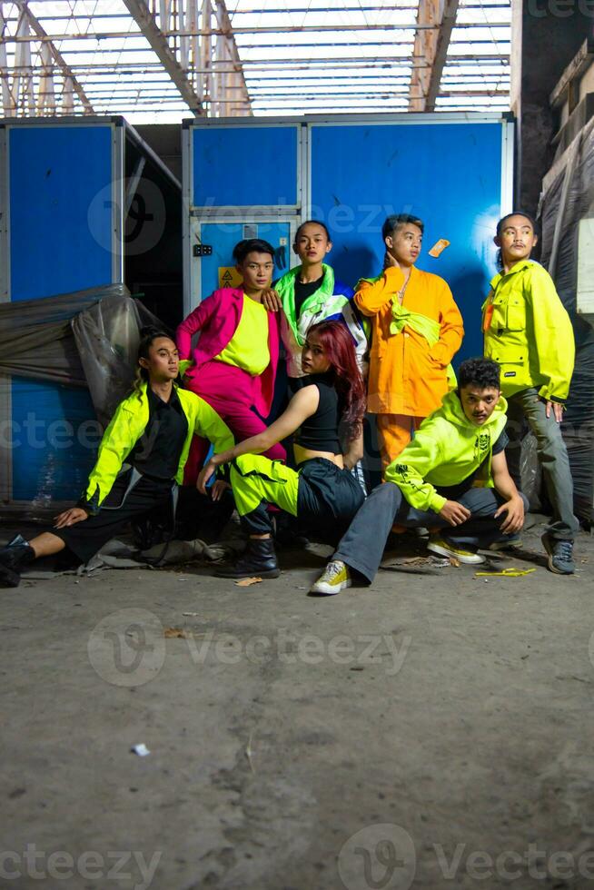 a group of Asian gay men posing around an abandoned building with their friends photo