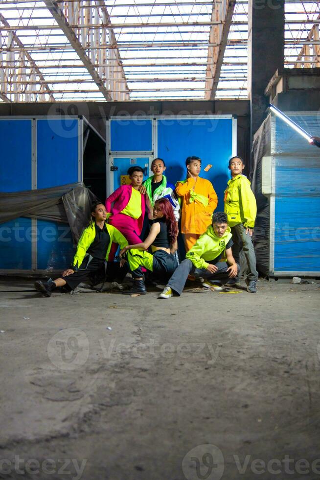 a group of Asian gay men posing around an abandoned building with their friends photo