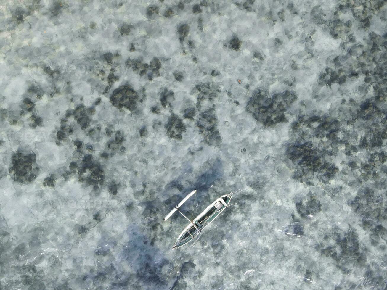 Top view or aerial view of beautiful clear water and white beach with long tail boats on summer tropical island called Karimunjawa in Jepara, Indonesia. photo