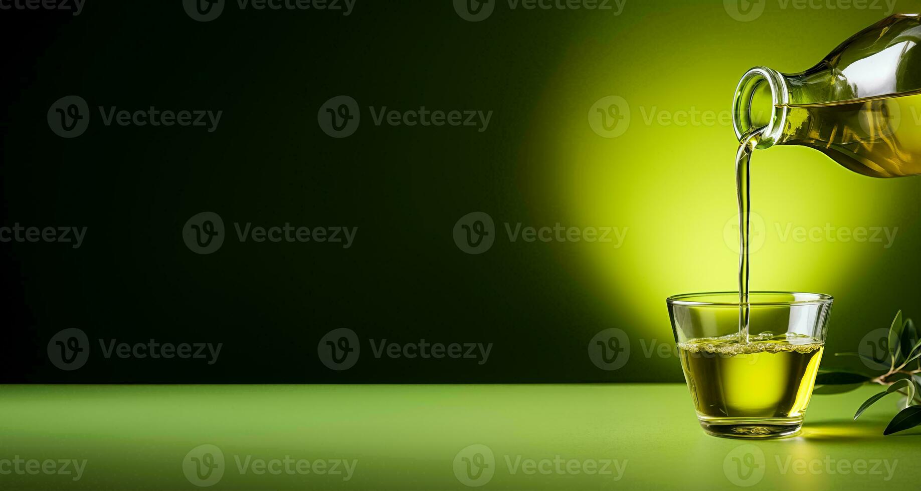 Hand pouring organic olive oil into a glass bottle isolated on a green gradient background photo