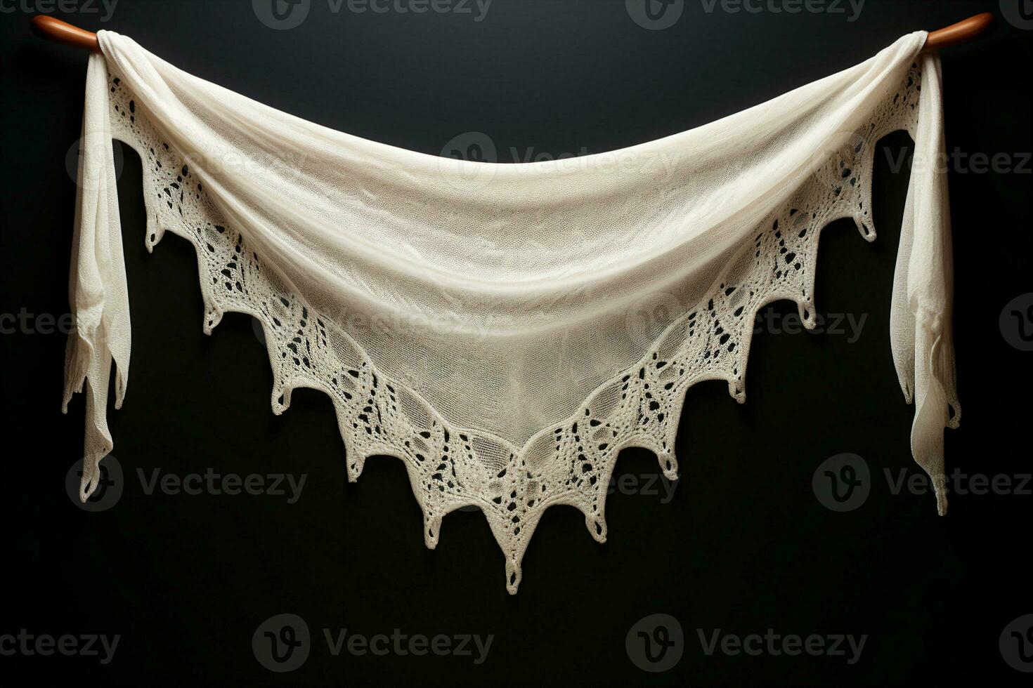 White crocheted shawl made of a light, airy fabric draped over a hanger on a wall. Warmth and coziness concept. AI Generated. photo