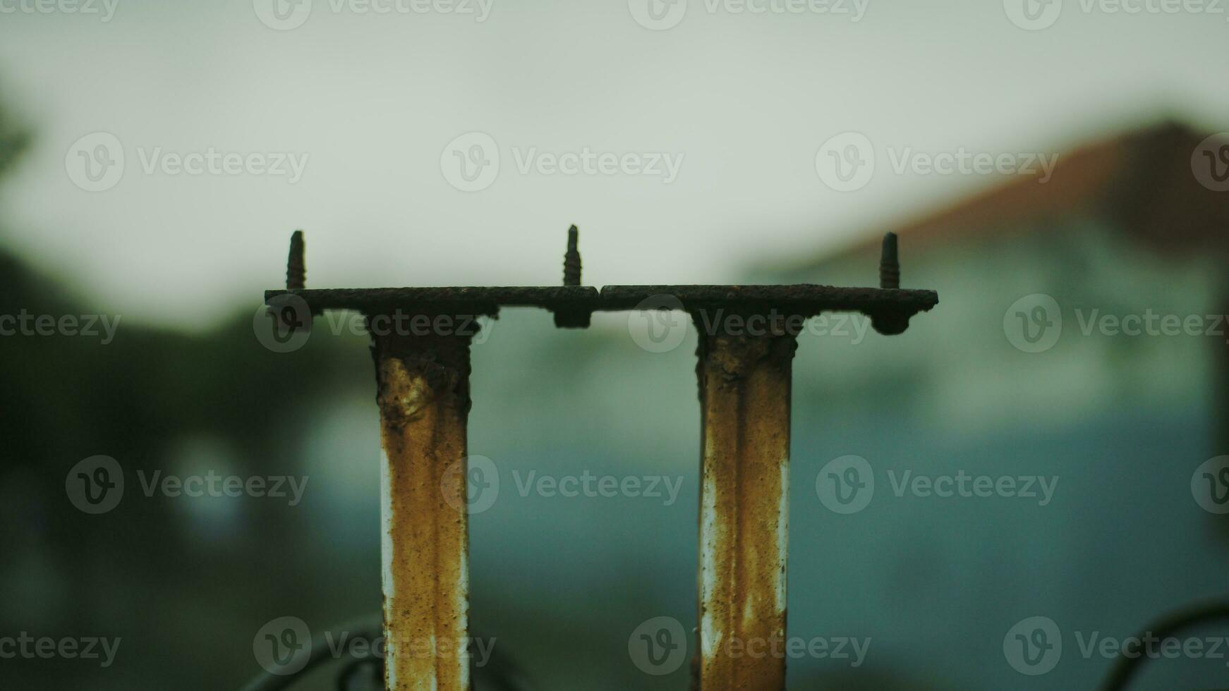 Blurred background of rusty iron fence posts. photo