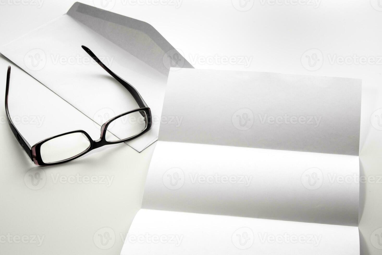 blank of letter paper and envelope with eyeglasses photo