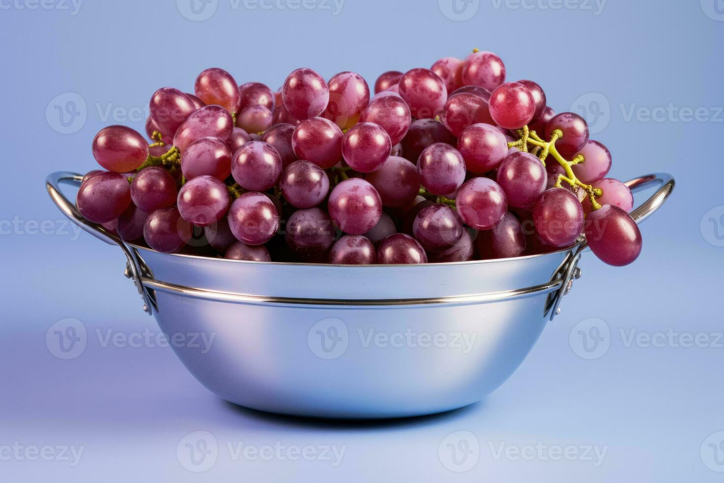 A stainless steel basket filled with sorted grapes isolated on a gradient background photo