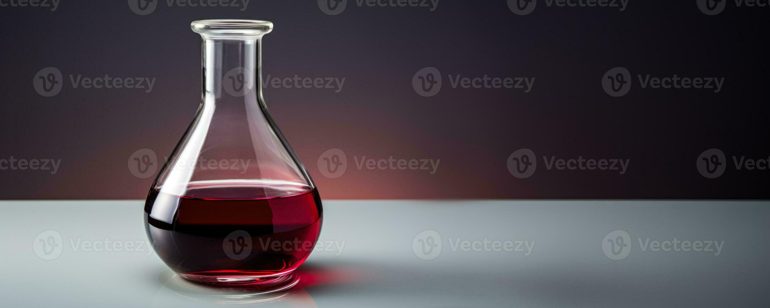 A laboratory flask containing red wine for testing isolated on a gradient background photo