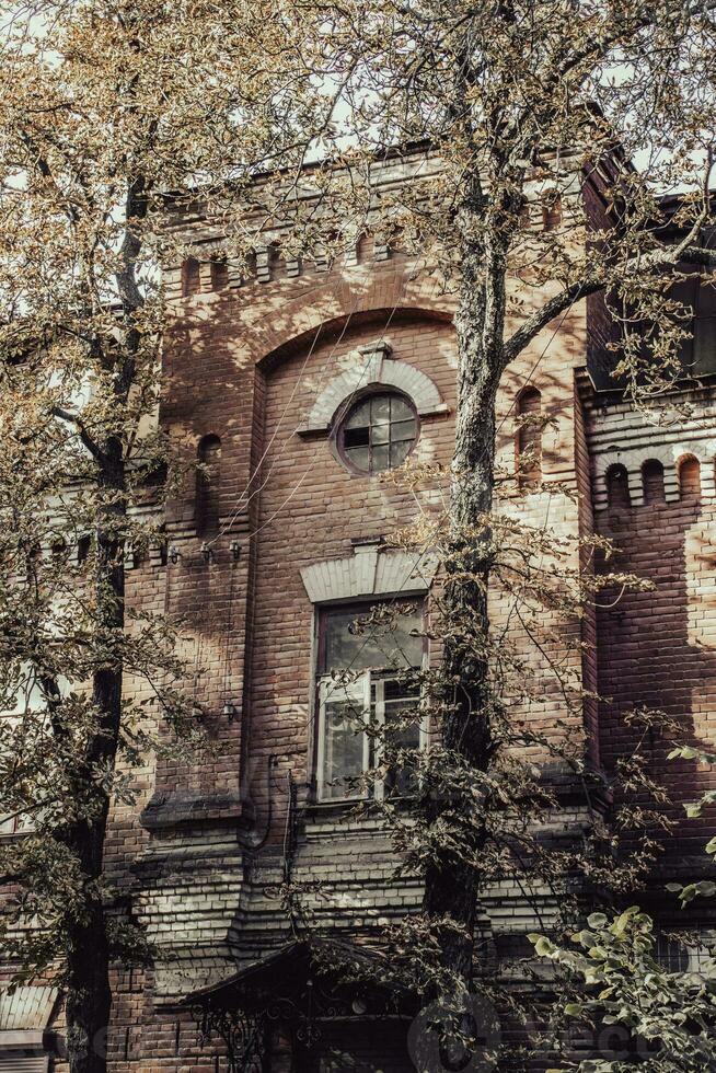 Old vintage brick building in autumn cityscape concept photo