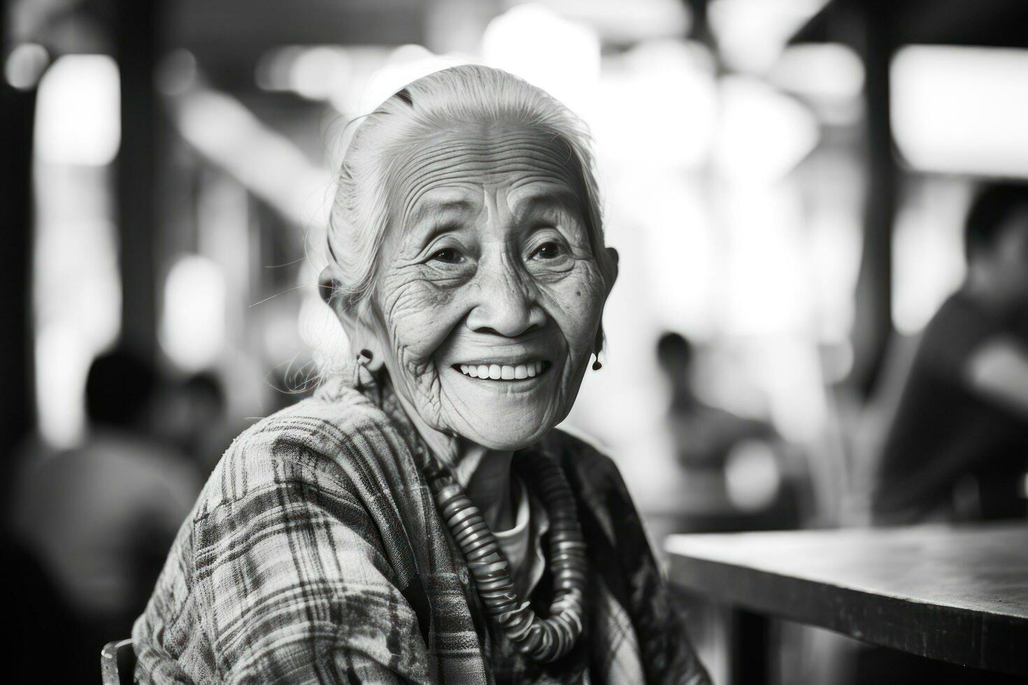 A smiling senior woman is sitting at a cafe photo