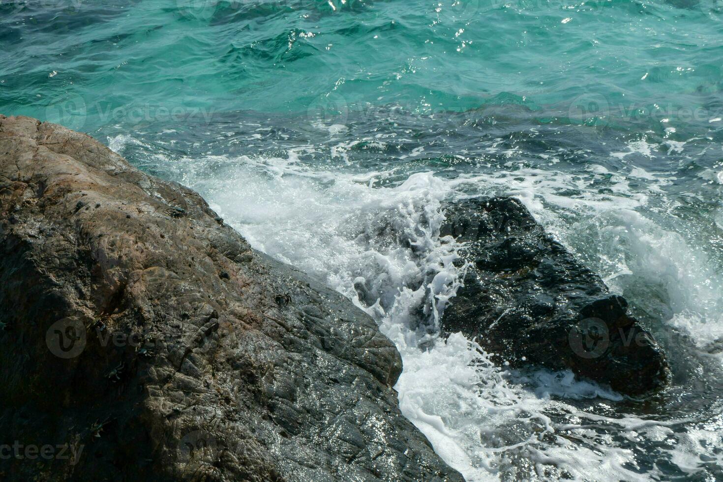 Beautiful scenic seascape blue ocean sea water on rock coast beach with splash wave on island, sky summer stone cliff coastal tide background for travel and tourism, high power turquoise pacific photo