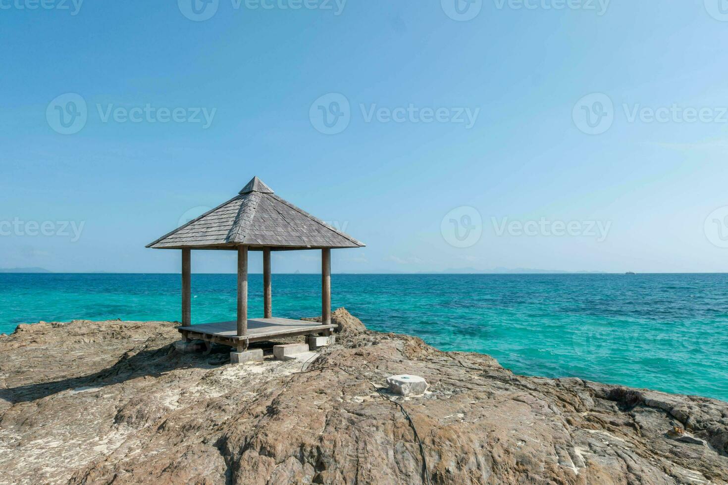 Beautiful scenery pavilion on rock coast with blue sea ocean water and sky, scenic tropical outdoor landscape coastline travel in summer with horizon bay wave, tourism sun and sunrise asia landmark photo