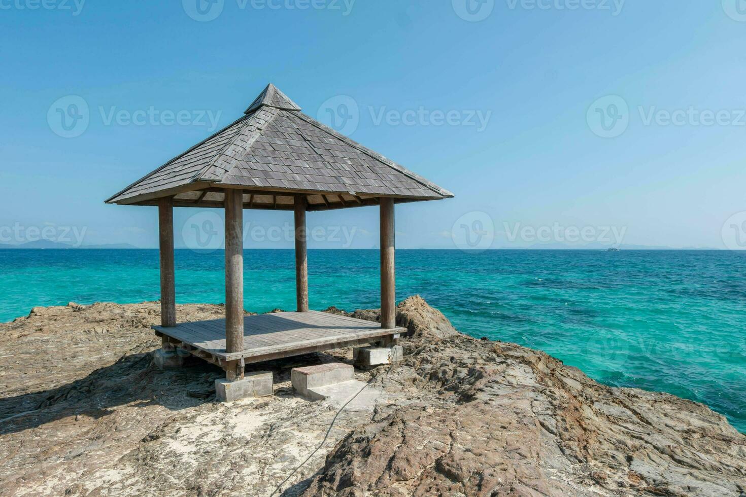 Beautiful scenery pavilion on rock coast with blue sea ocean water and sky, scenic tropical outdoor landscape coastline travel in summer with horizon bay wave, tourism sun and sunrise asia landmark photo