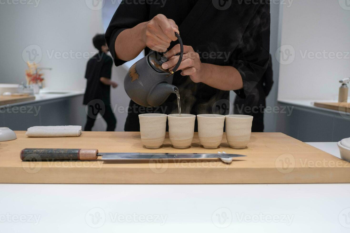 Professional chef preparing and cooking raw fresh fish ingredient on the table with knife for delicious sushi and sashimi meal, Person making luxury omakase fine dining Japanese food restaurant dinner photo