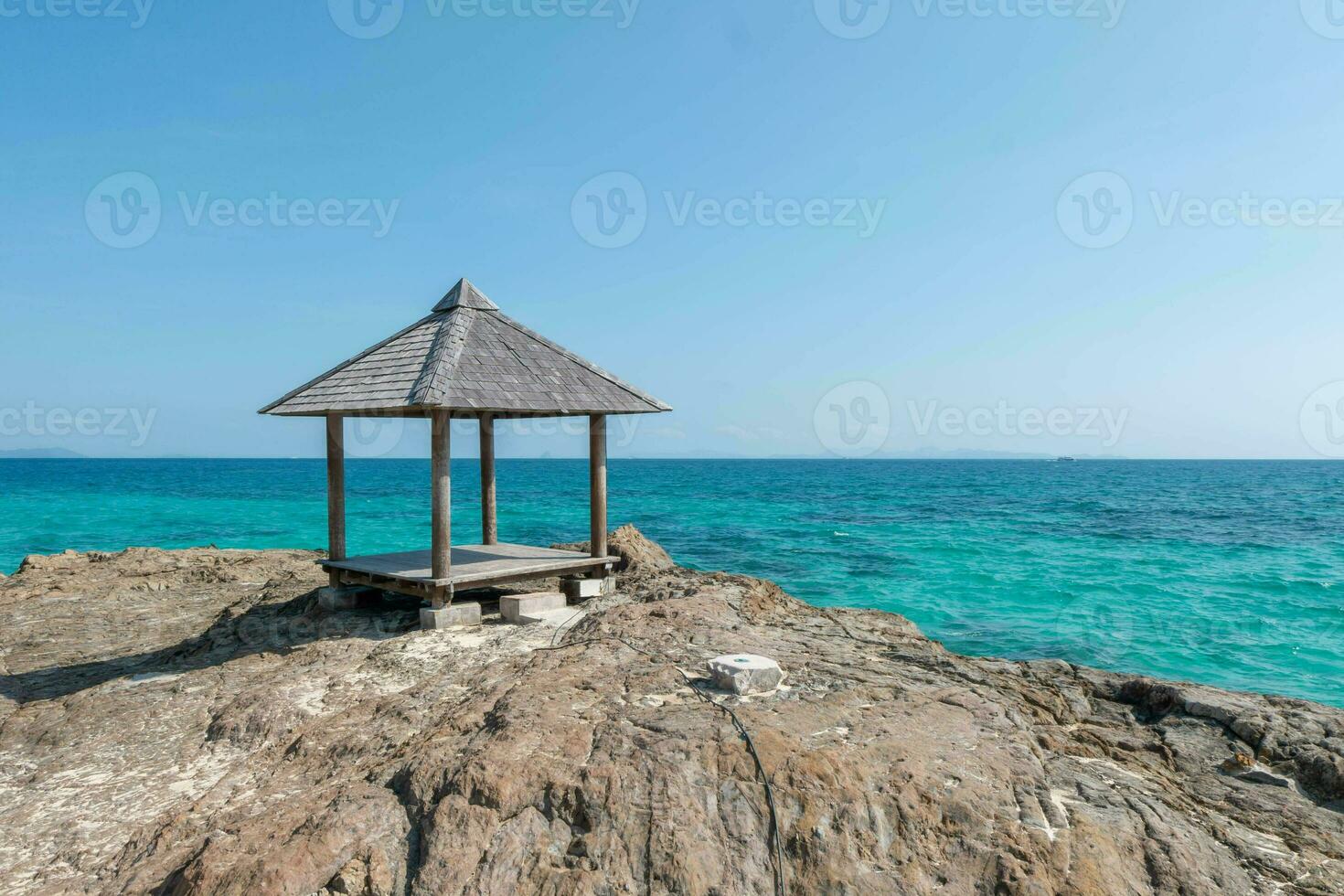 Beautiful scenery pavilion on rock coast with blue sea ocean water and sky, scenic tropical outdoor landscape coastline travel in summer with horizon bay wave, tourism sun and sunrise asia landmark photo