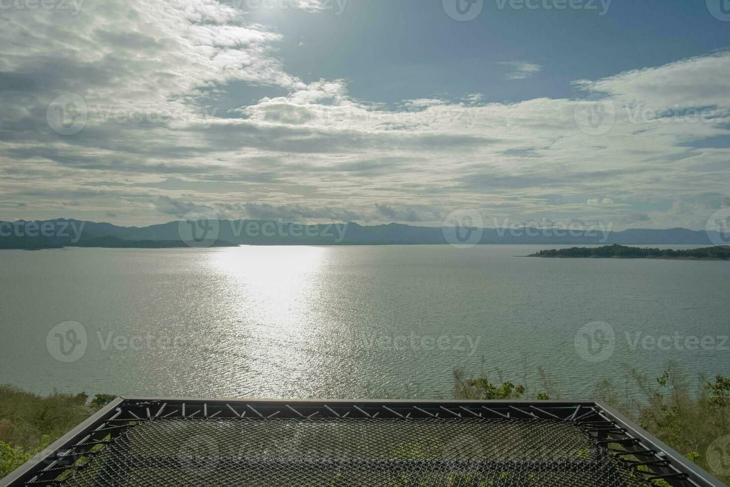 Travel for beautiful nature lake sunset with hammock, Relax vacation with landscape sky and evening sunlight, Calm outdoor holiday water reflection with cloud view background, peaceful calm horizon photo