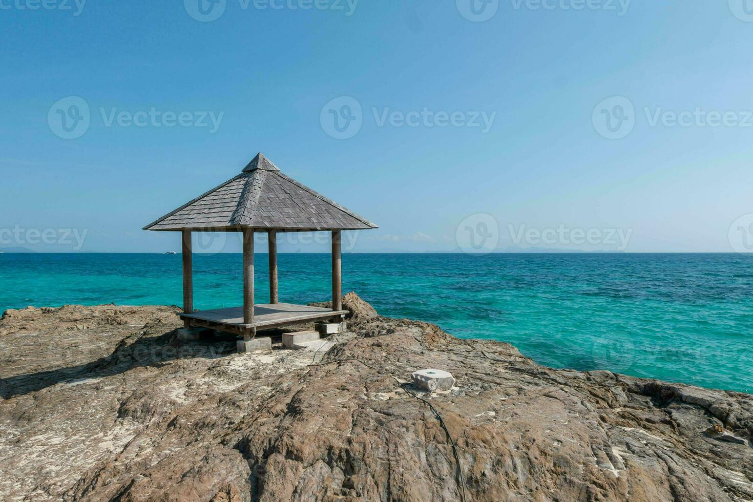 Beautiful scenery pavilion on rock coast with blue sea ocean water and sky, scenic tropical outdoor landscape coastline travel in summer with horizon bay wave, tourism sun and sunrise asia landmark photo