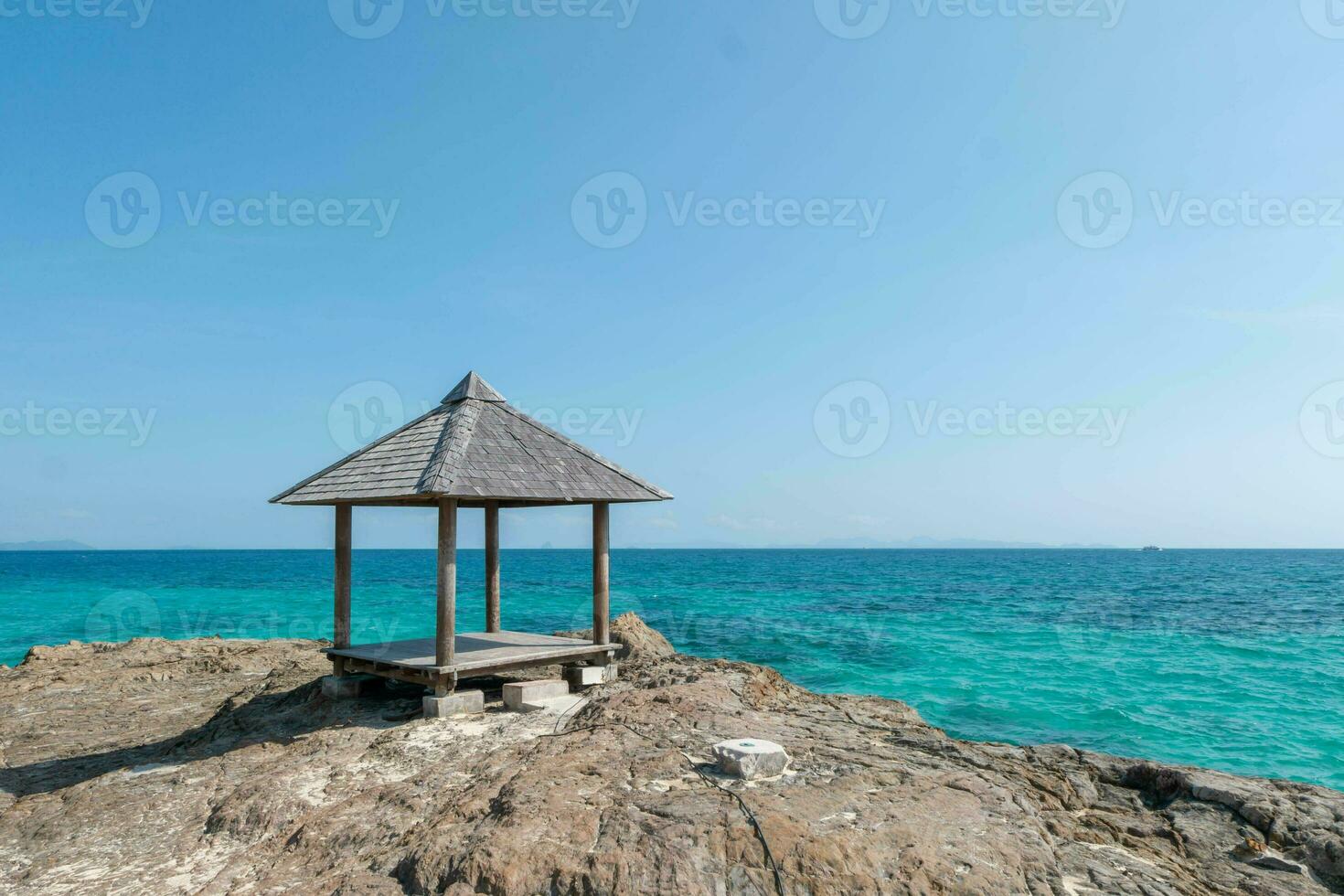 Beautiful scenery pavilion on rock coast with blue sea ocean water and sky, scenic tropical outdoor landscape coastline travel in summer with horizon bay wave, tourism sun and sunrise asia landmark photo