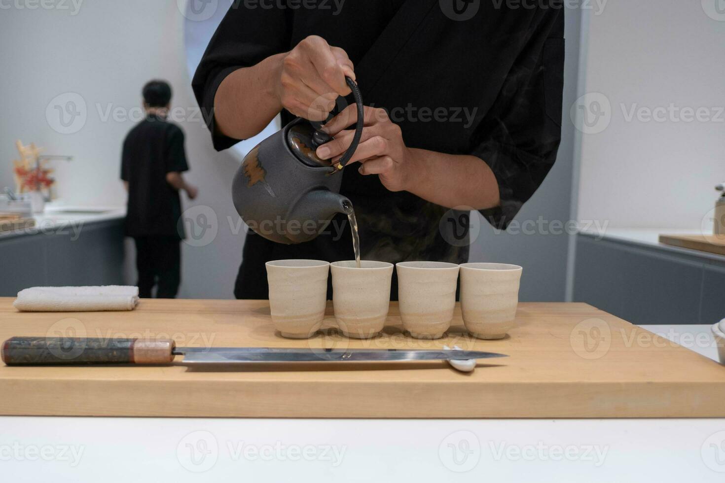 Professional chef preparing and cooking raw fresh fish ingredient on the table with knife for delicious sushi and sashimi meal, Person making luxury omakase fine dining Japanese food restaurant dinner photo