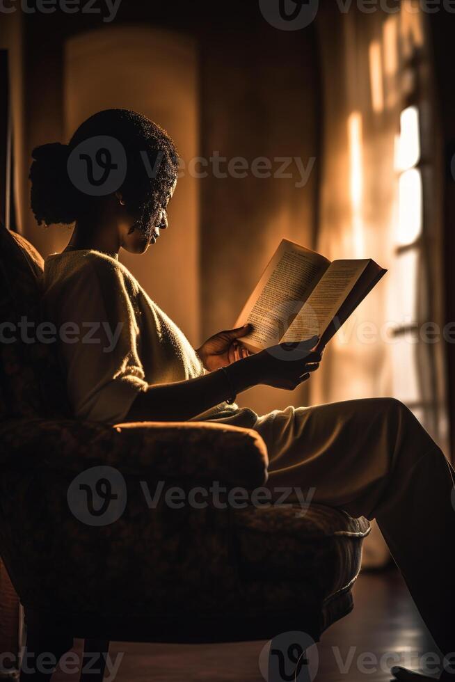 a silhouette of a person reading a book photo